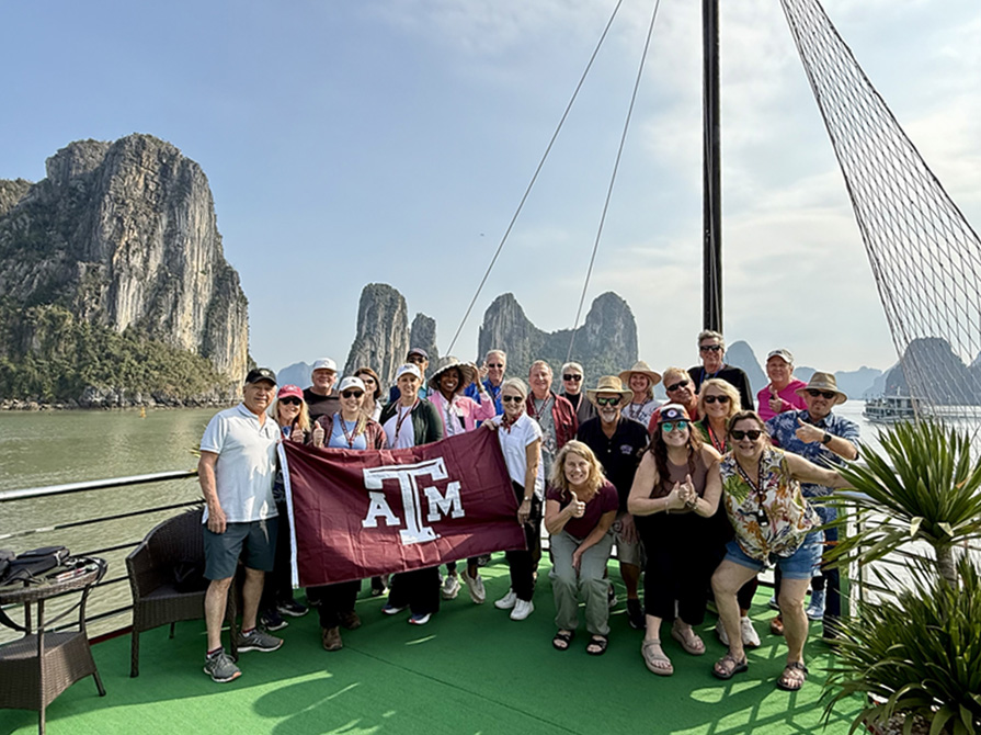 International A&M Club holding a Texas A&M flag