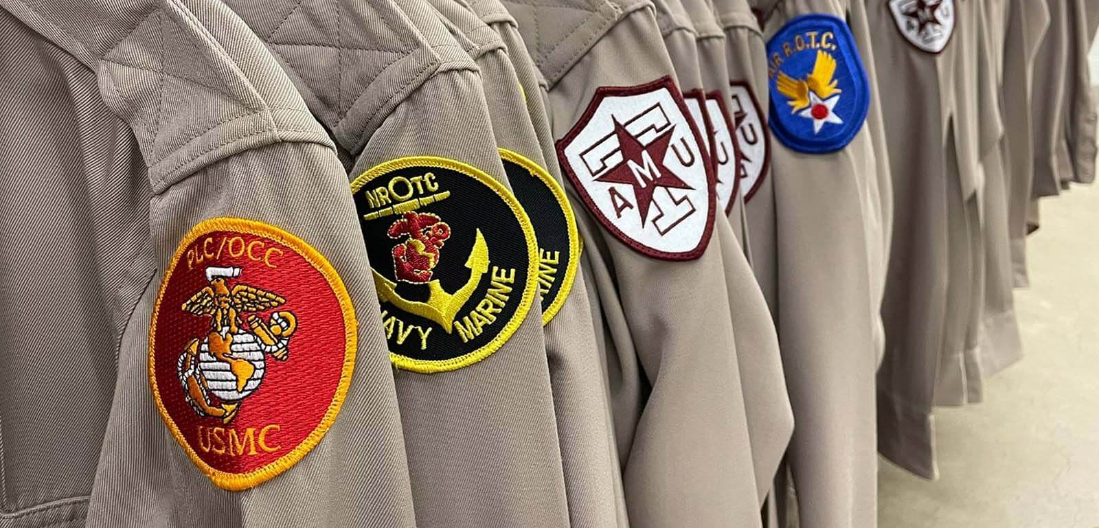 Photo of hanging uniforms with sleeve patches