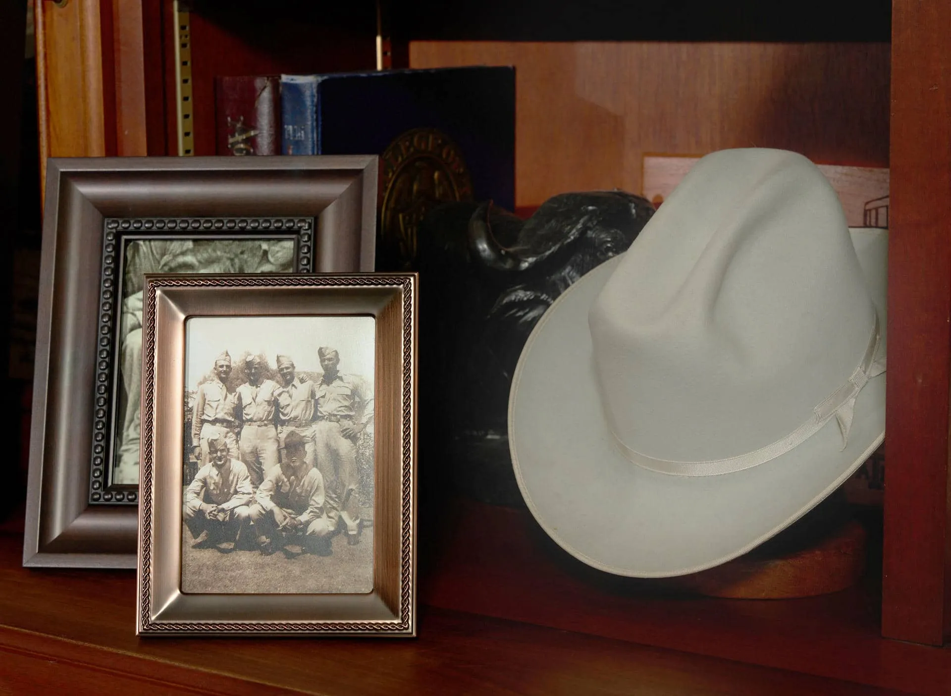 Porter S. Garner Jr.’s hat on a shelf beside a World War II reunion photo