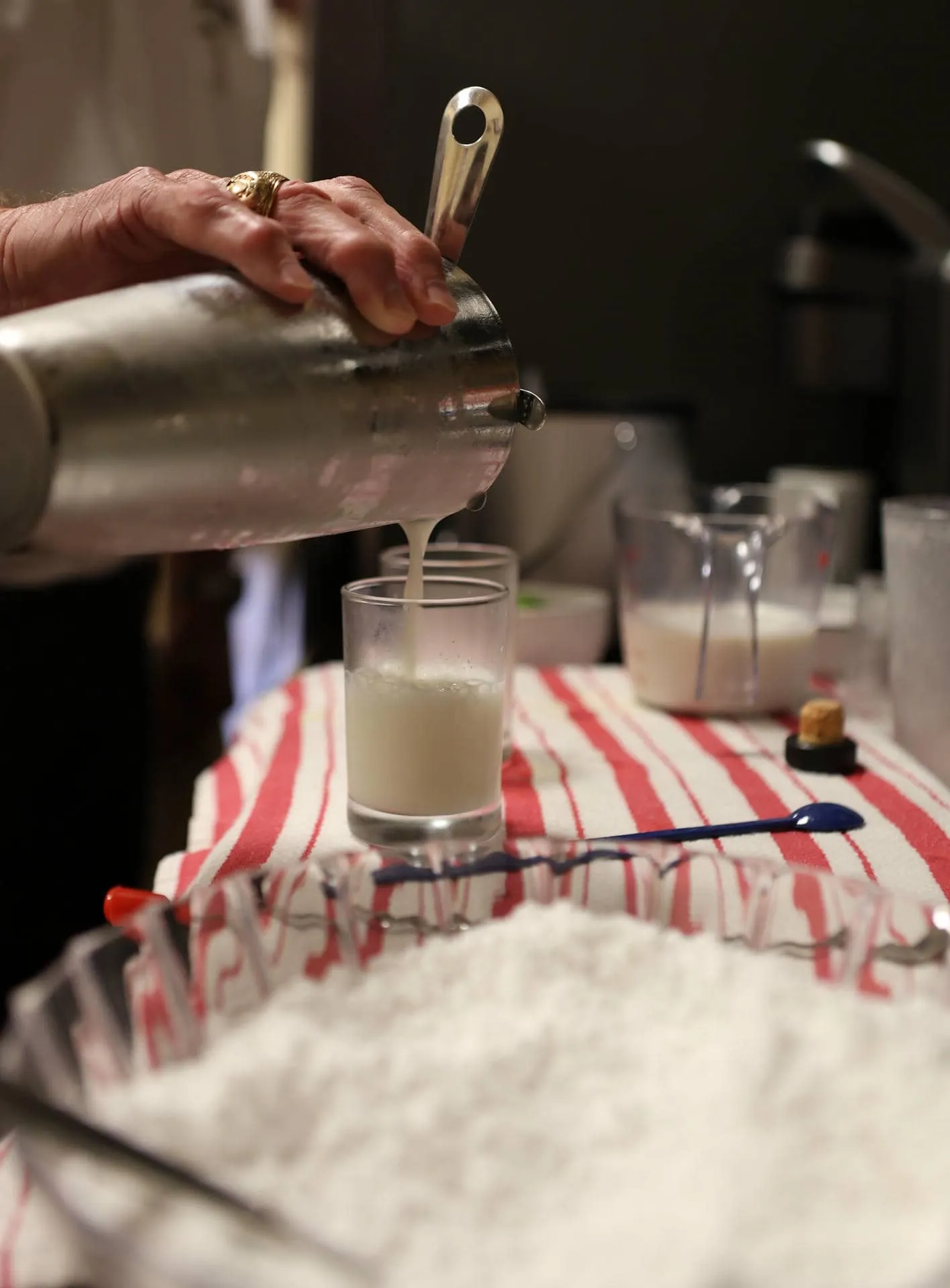 Porter Garner pouring a frothy Ramos Gin Fizz into a chilled glass