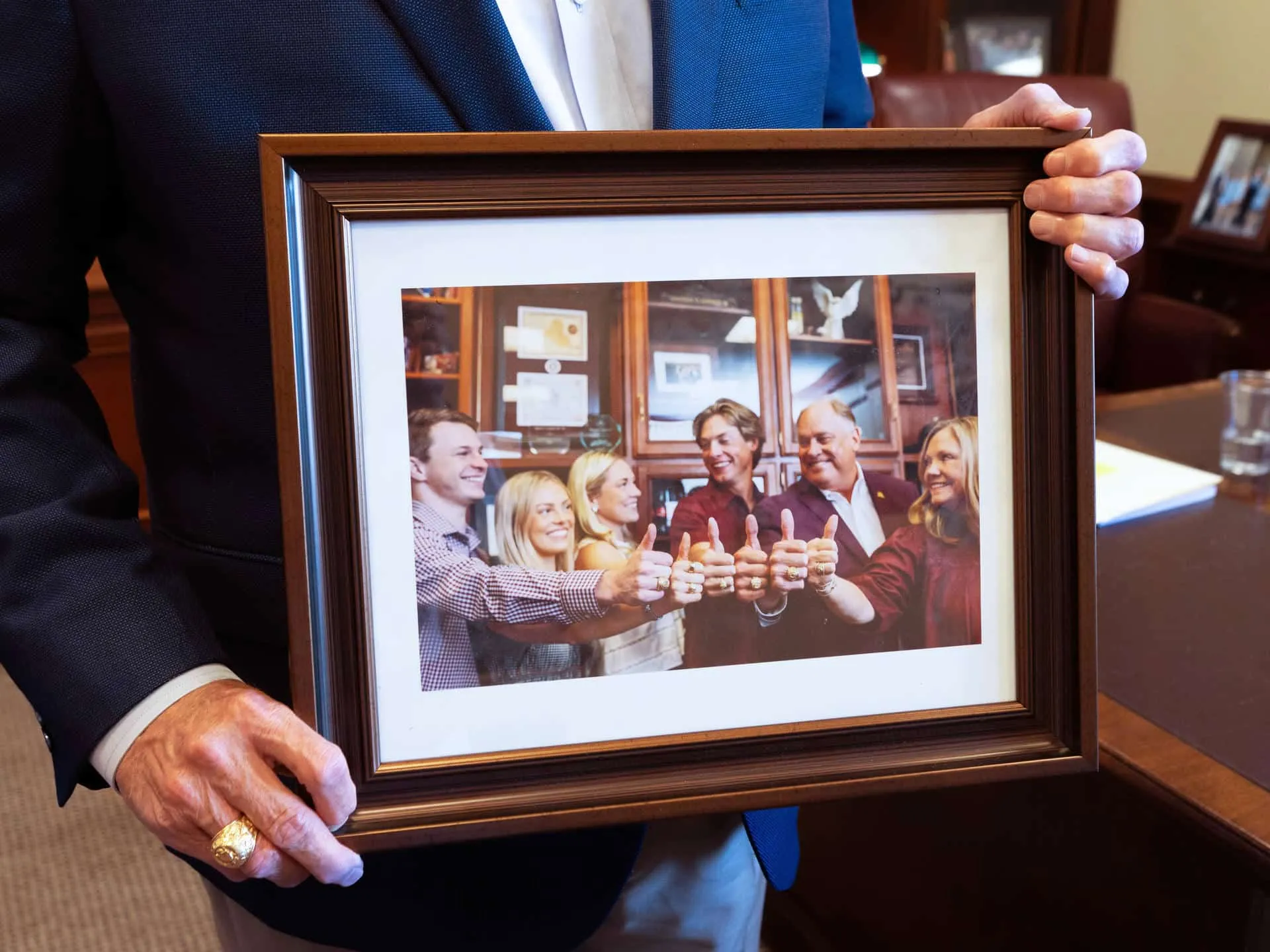 A framed family photo of the Garners on the bookcase