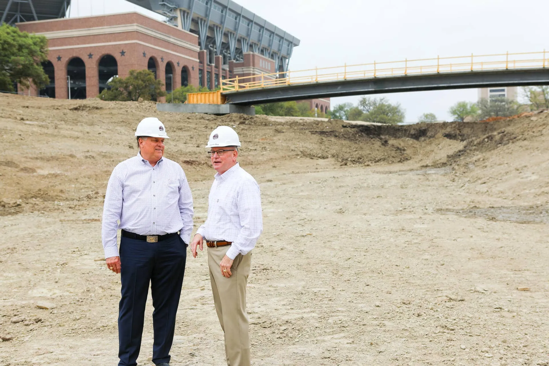 Garner and Marty Holmes walking the dry, unfinished lake bed at Aggie Park in April 2022