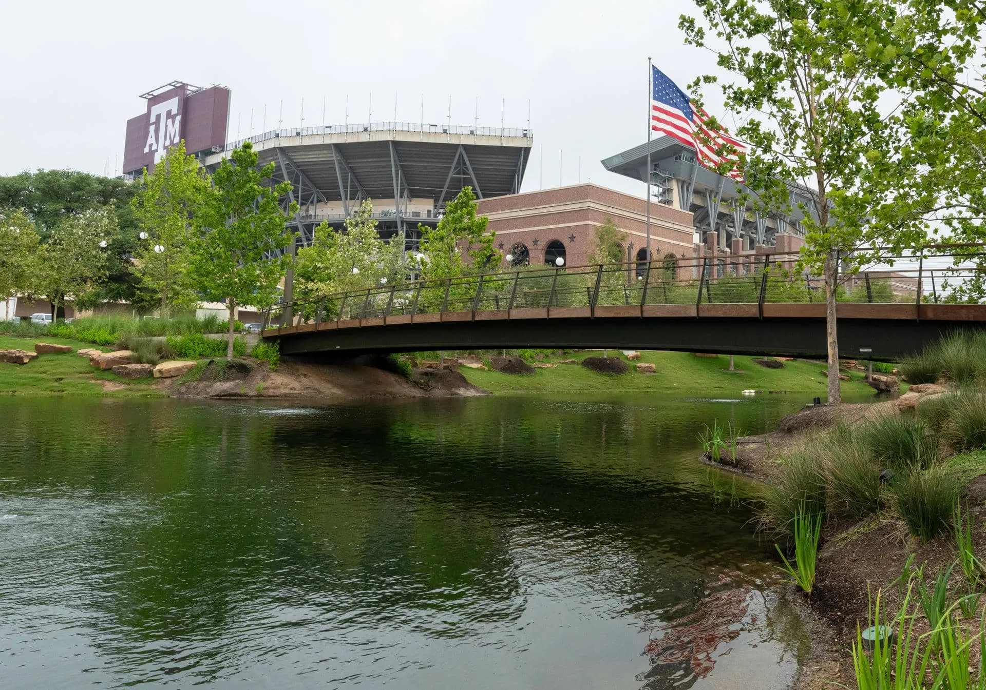 The finished Aggie Park lake and Plank Bridge, landscaped and full of water