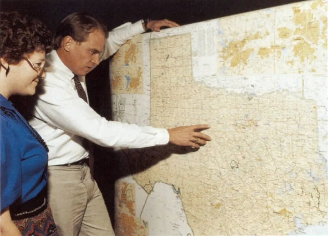 Porter Garner and assistant Vickie Young marking a wall map of A&M Clubs
